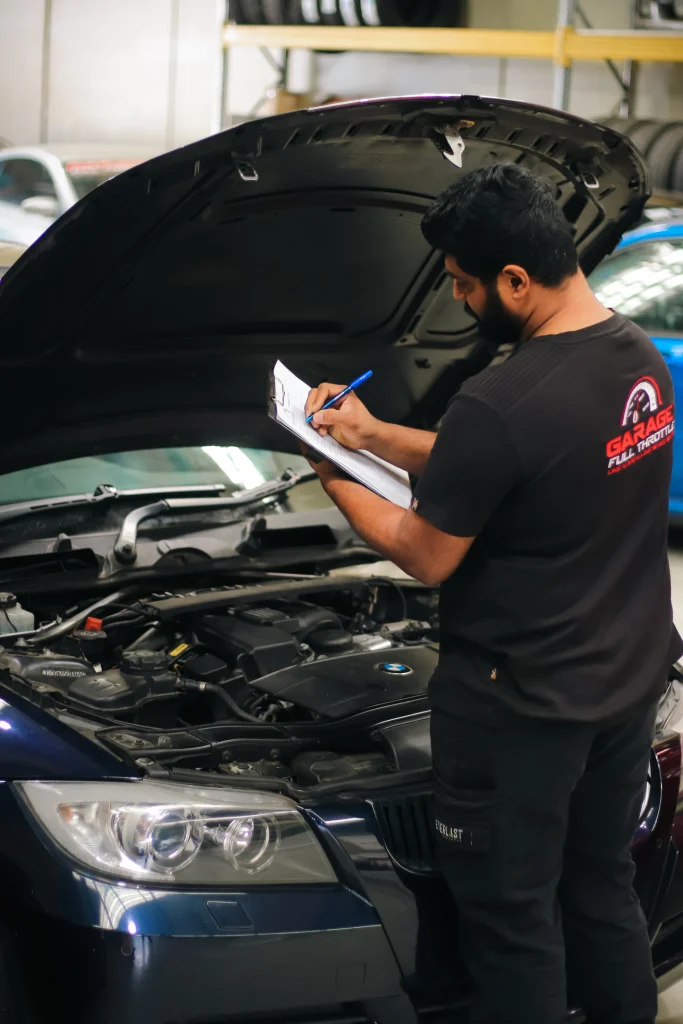 Mechanic completing Logbook Service at Garage Full Throttle