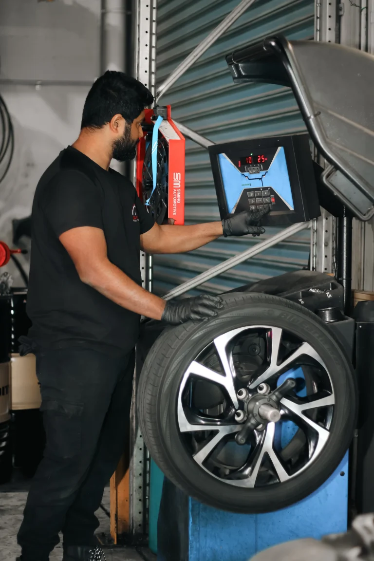 Garage Full Throttle Mechanic Doing A Tyre Service