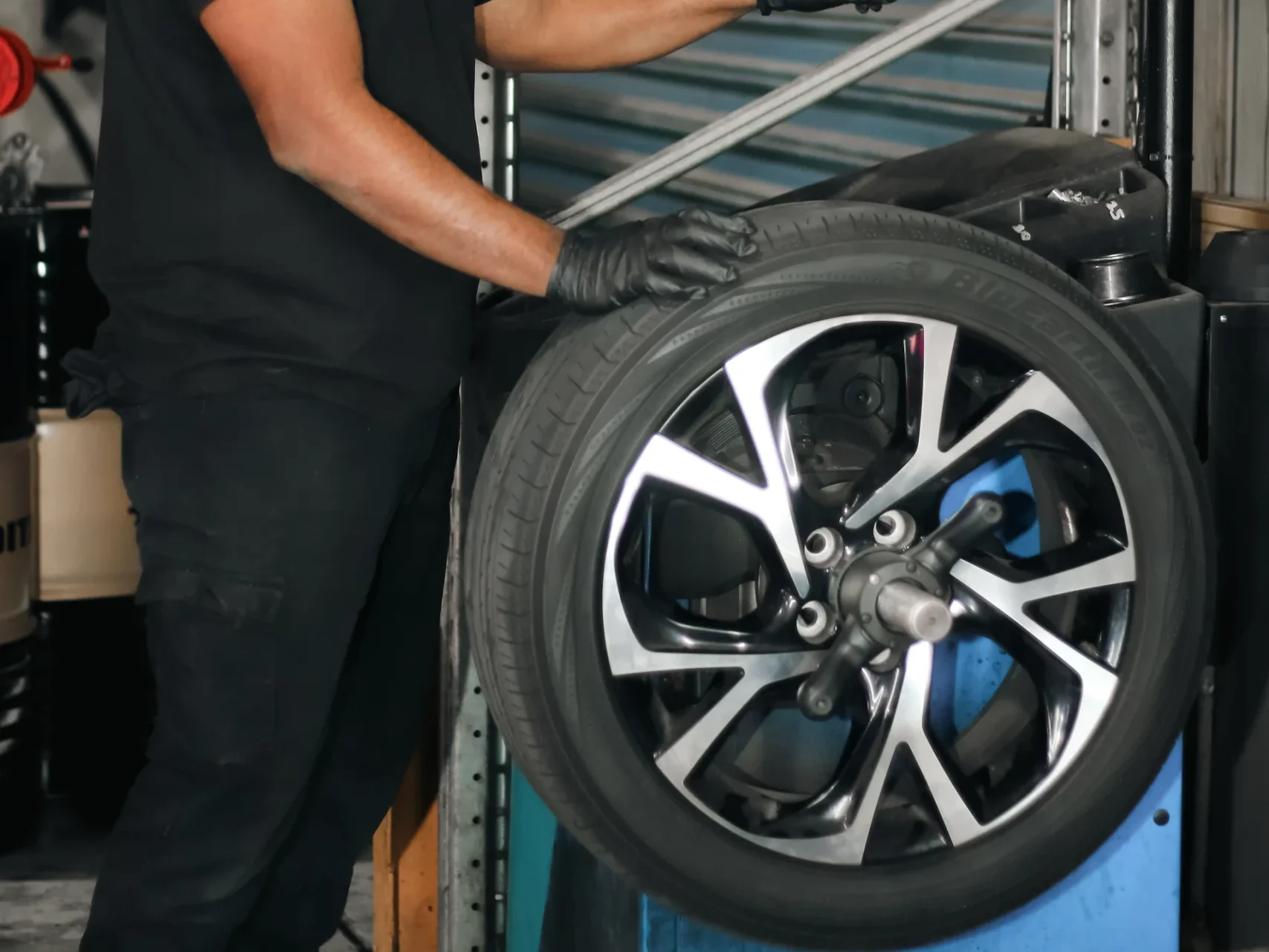 Garage Full Throttle Mechanic Doing A Tyre Service