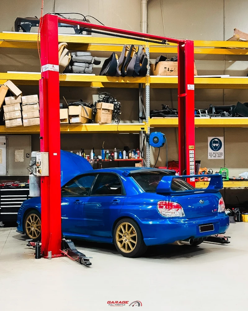 Subaru WRX STI on hoist ready for roadworthy repair service at Garage Full Throttle fast-track workshop in Craigieburn